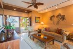 The living room features sofa, arm chairs, coffee table, AC and large flat screen TV.